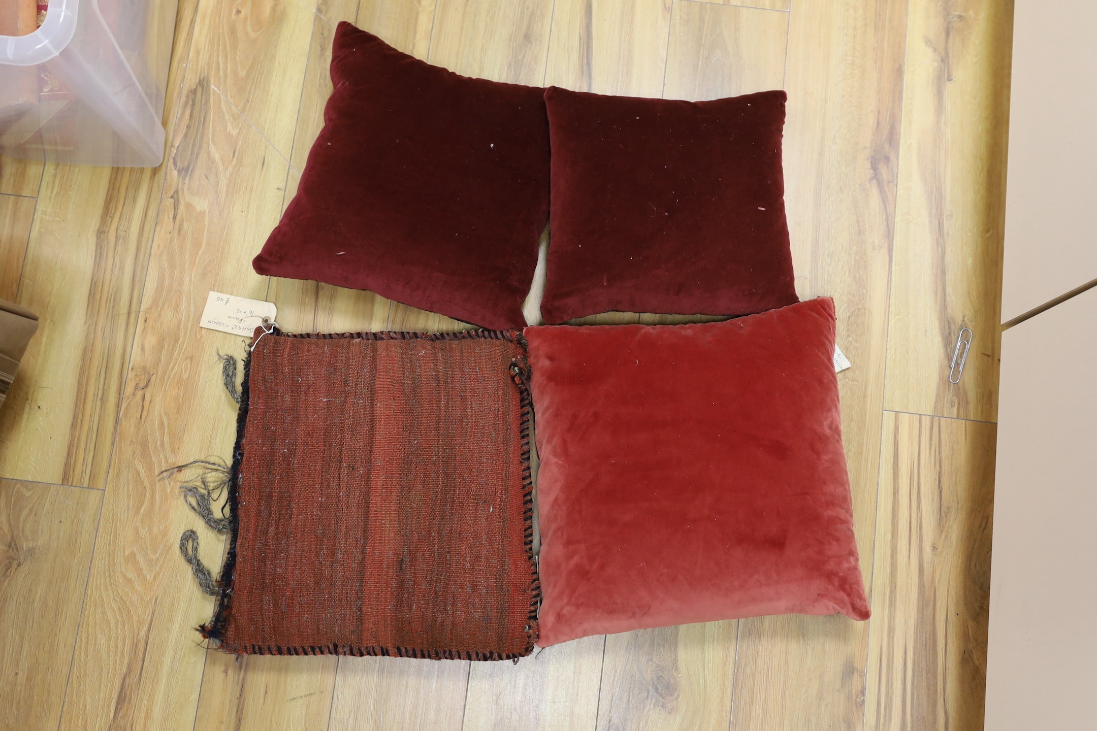 A pair of antique Persian belouch cushions, together with an Afghani Chubbash cushion, 16